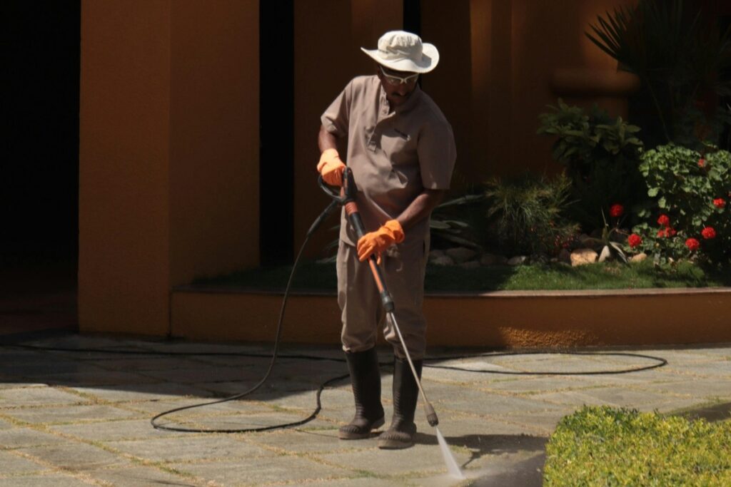 A man pressure washing a driveway.